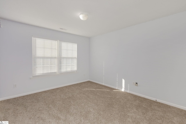 unfurnished room featuring visible vents, baseboards, and carpet floors