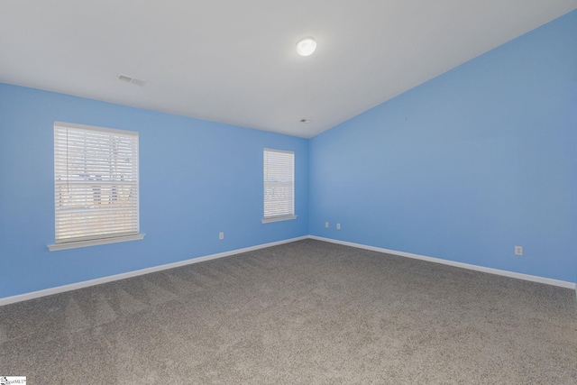 carpeted empty room featuring visible vents and baseboards