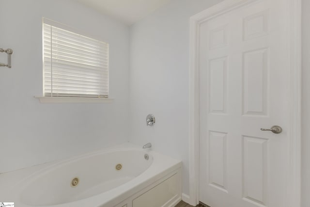 full bathroom featuring a tub with jets