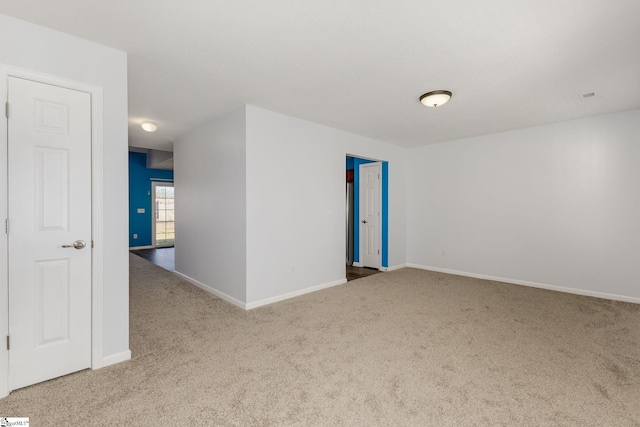 unfurnished room featuring baseboards and carpet floors