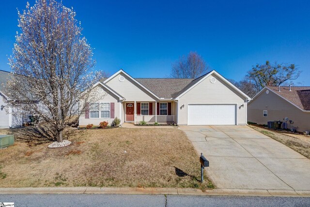 ranch-style home with a front lawn, a porch, central AC unit, a garage, and driveway