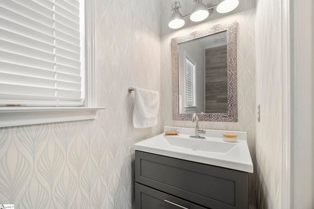 bathroom with vanity and wallpapered walls