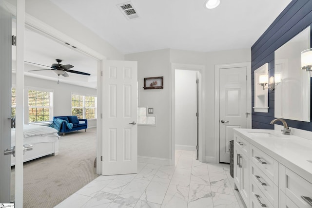 ensuite bathroom featuring visible vents, marble finish floor, connected bathroom, baseboards, and vanity