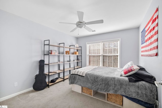 bedroom with a ceiling fan, baseboards, and carpet floors