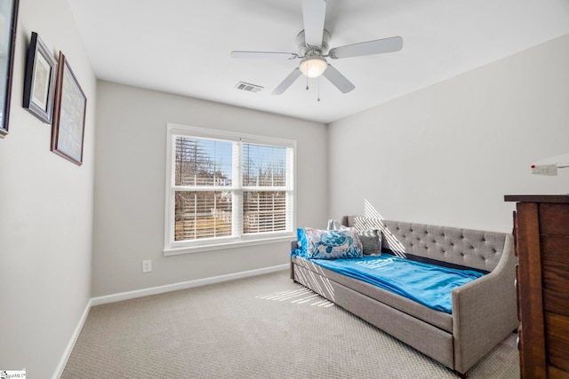 carpeted bedroom with visible vents, a ceiling fan, and baseboards