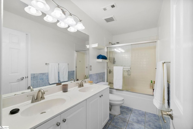 bathroom featuring tile patterned floors, visible vents, and a sink