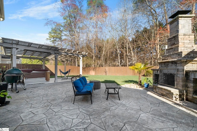 view of patio featuring grilling area, a hot tub, an outdoor stone fireplace, a fenced backyard, and a pergola