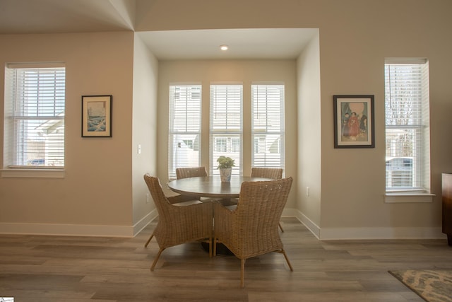 dining space featuring recessed lighting, wood finished floors, and baseboards