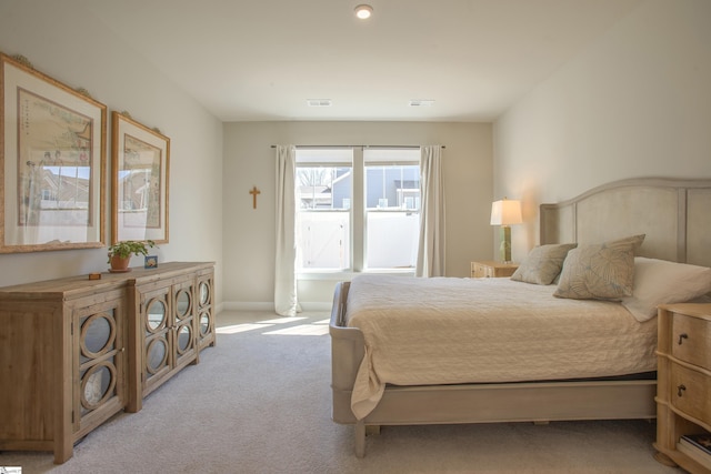 bedroom featuring visible vents and light carpet