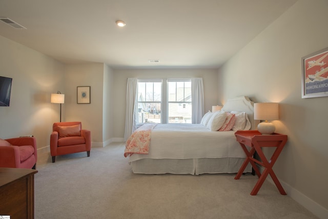 carpeted bedroom featuring visible vents and baseboards