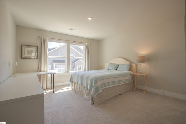 bedroom featuring visible vents, baseboards, and carpet