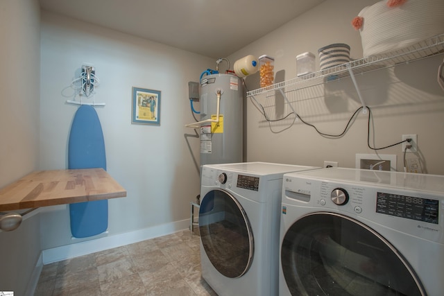 washroom featuring washer and clothes dryer, laundry area, electric water heater, and baseboards