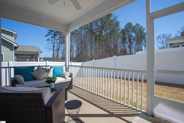 balcony with an outdoor living space and a ceiling fan