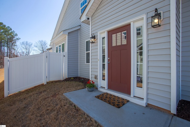 entrance to property featuring a gate and fence