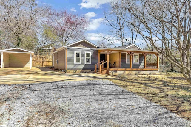 view of front facade with crawl space, covered porch, concrete driveway, and fence