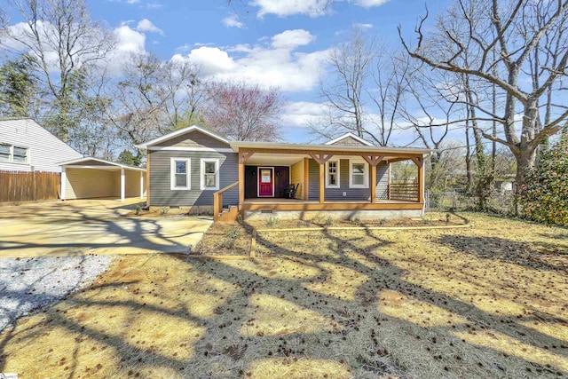 view of front facade featuring fence, covered porch, and crawl space