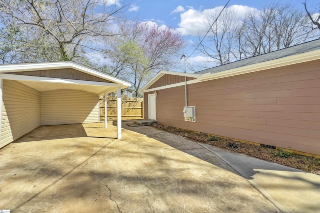 exterior space featuring driveway and fence