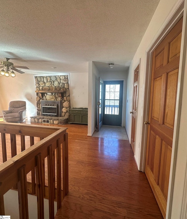 hallway featuring wood finished floors and a textured ceiling