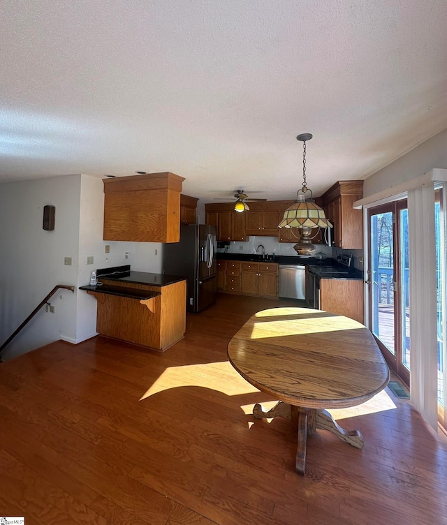 kitchen with dark countertops, black fridge, dishwasher, and range with electric cooktop