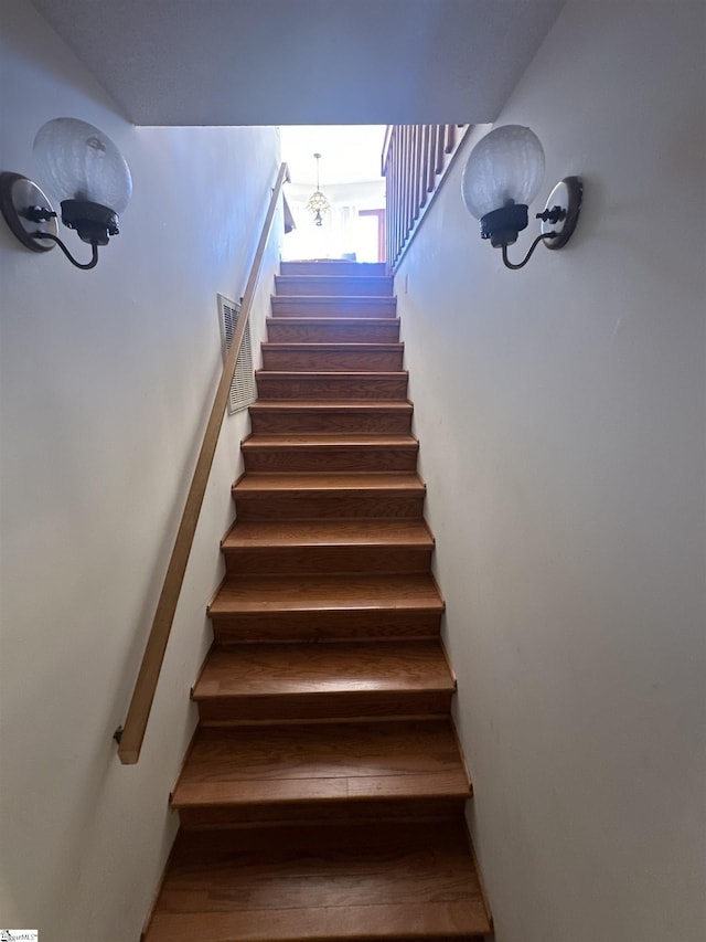 stairs featuring wood finished floors