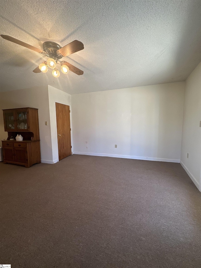 interior space with ceiling fan, a textured ceiling, baseboards, and carpet