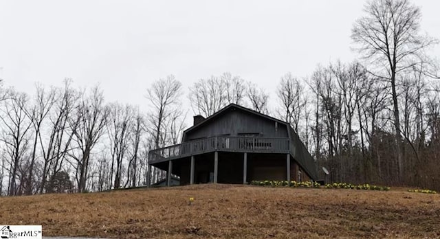 exterior space featuring a chimney and a deck