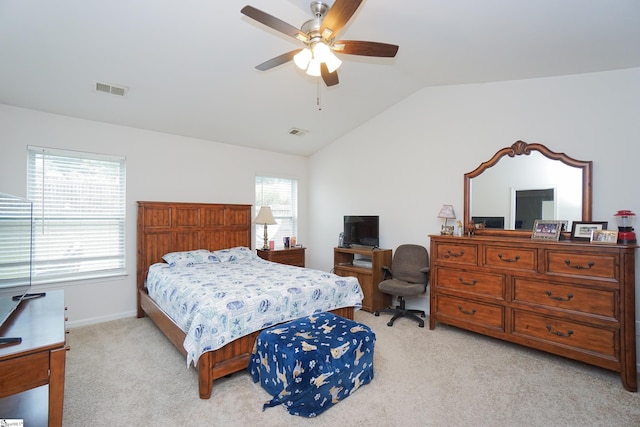 bedroom with visible vents, light colored carpet, ceiling fan, and vaulted ceiling