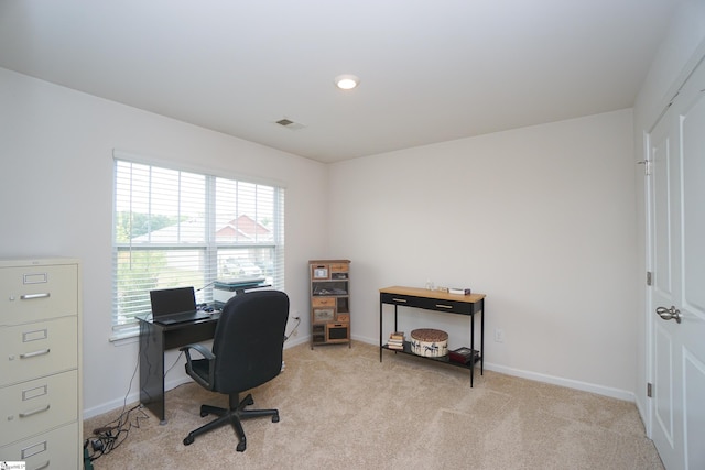 office space with light carpet, visible vents, and baseboards