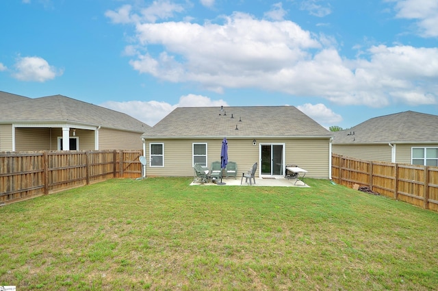 back of property with a patio, a lawn, and a fenced backyard