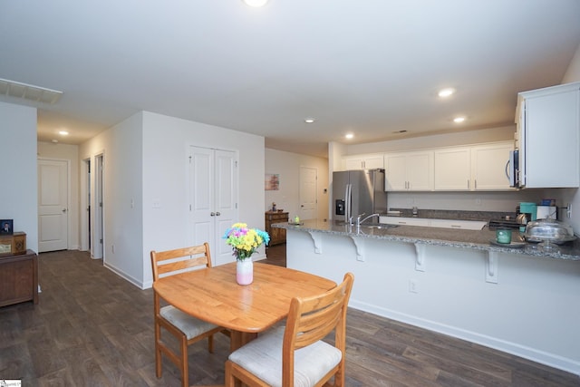 dining room with recessed lighting, visible vents, baseboards, and dark wood-style floors