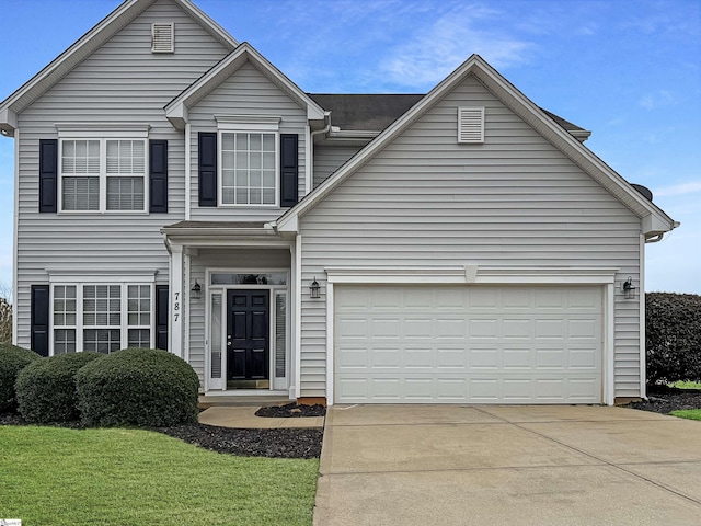 traditional home with concrete driveway, a garage, and a front yard