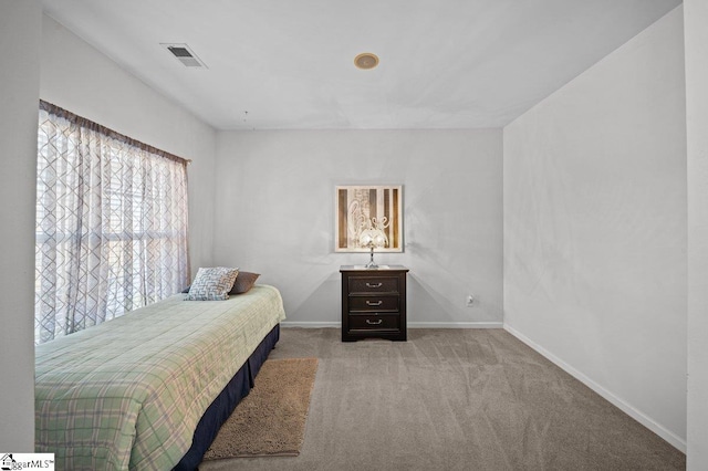 bedroom featuring baseboards, visible vents, and carpet floors