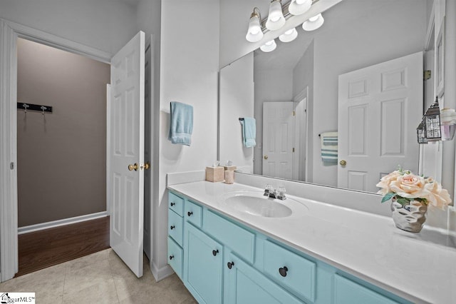 bathroom with vanity, tile patterned floors, and baseboards