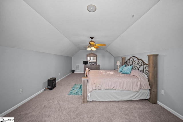 carpeted bedroom with visible vents, ceiling fan, baseboards, and vaulted ceiling