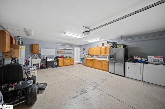 garage with washing machine and clothes dryer, a sink, a garage door opener, and stainless steel fridge with ice dispenser