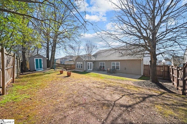 back of property featuring a fenced backyard, a yard, and an outdoor structure