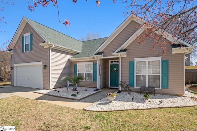 view of front facade featuring a front lawn, an attached garage, driveway, and a shingled roof