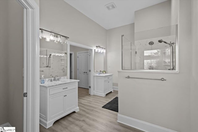 145 Brady Dr, Anderson, SC 29626 - full bath featuring wood finished floors, baseboards, two vanities, a sink, and a shower stall