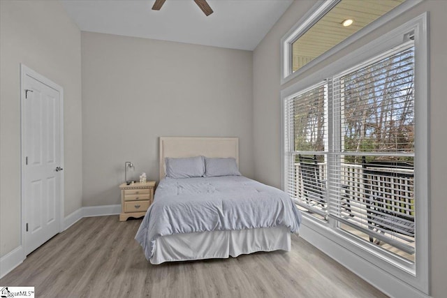 bedroom featuring a ceiling fan, baseboards, and wood finished floors