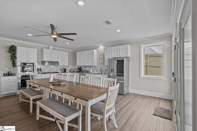 145 Brady Dr, Anderson, SC 29626 - dining room with visible vents, ornamental molding, a ceiling fan, light wood finished floors, and baseboards