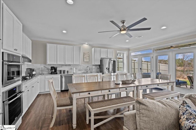 145 Brady Dr, Anderson, SC 29626 - kitchen featuring white cabinetry, crown molding, tasteful backsplash, and appliances with stainless steel finishes