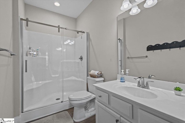 145 Brady Dr, Anderson, SC 29626 - bathroom featuring vanity, toilet, wood finished floors, and a stall shower