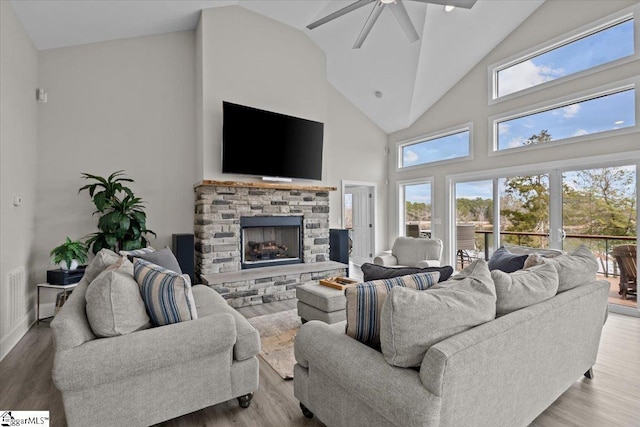 145 Brady Dr, Anderson, SC 29626 - living area with a stone fireplace, wood finished floors, a wealth of natural light, and a ceiling fan