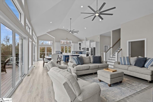 145 Brady Dr, Anderson, SC 29626 - living area with a ceiling fan, high vaulted ceiling, recessed lighting, stairs, and light wood-type flooring