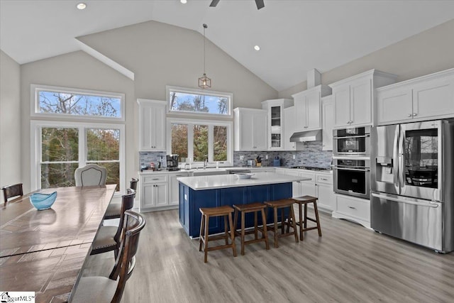 145 Brady Dr, Anderson, SC 29626 - kitchen with a breakfast bar area, stainless steel appliances, light countertops, white cabinetry, and a center island