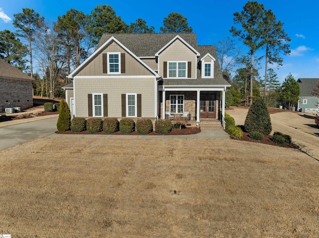 view of front of home with a shingled roof and a front yard