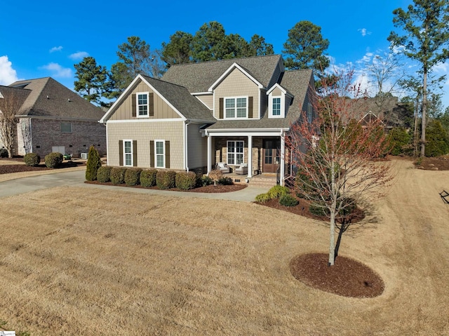 view of front of house featuring a porch, board and batten siding, and a shingled roof