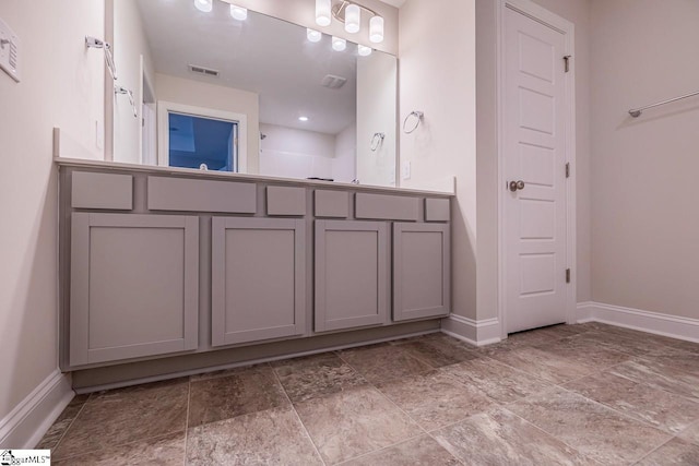 bathroom with baseboards and visible vents