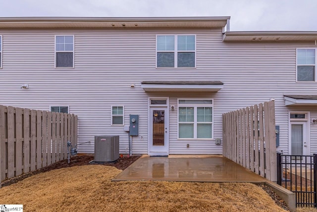 back of house featuring central air condition unit, a patio, and a fenced backyard