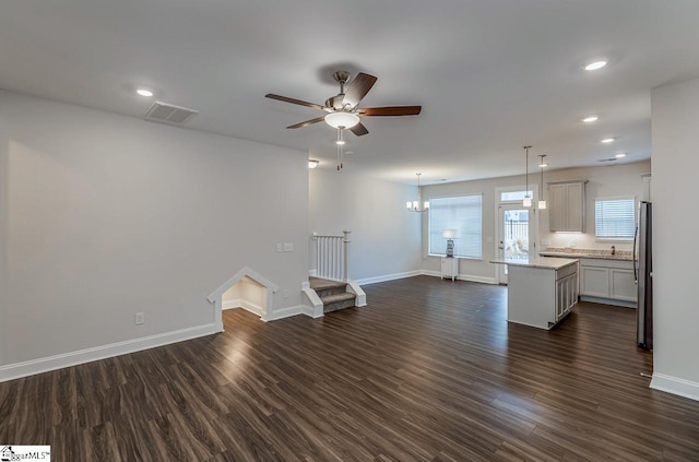 unfurnished living room with visible vents, baseboards, recessed lighting, dark wood-style floors, and a ceiling fan